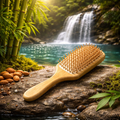 Wooden hairbrush on a rock with a waterfall and bamboo in the background